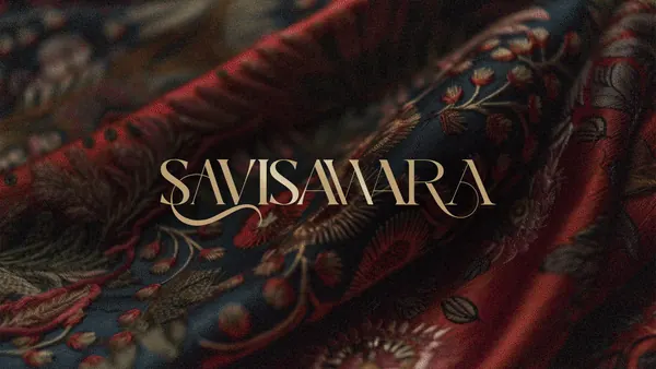 Savi Sawara wordmark shown in gold on patterned fabric