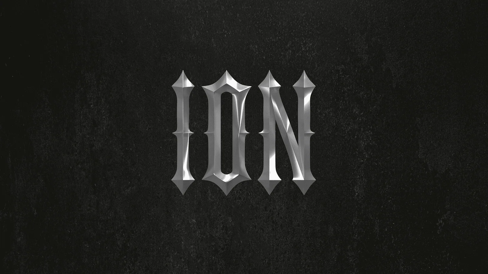 Silver blackletter Ion wordmark embossed on dark textured stone