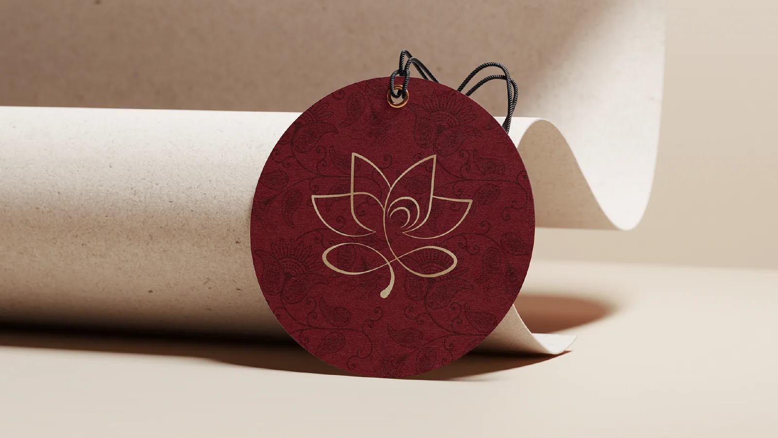 Maroon circular swing tag with the gold lotus mark and string
