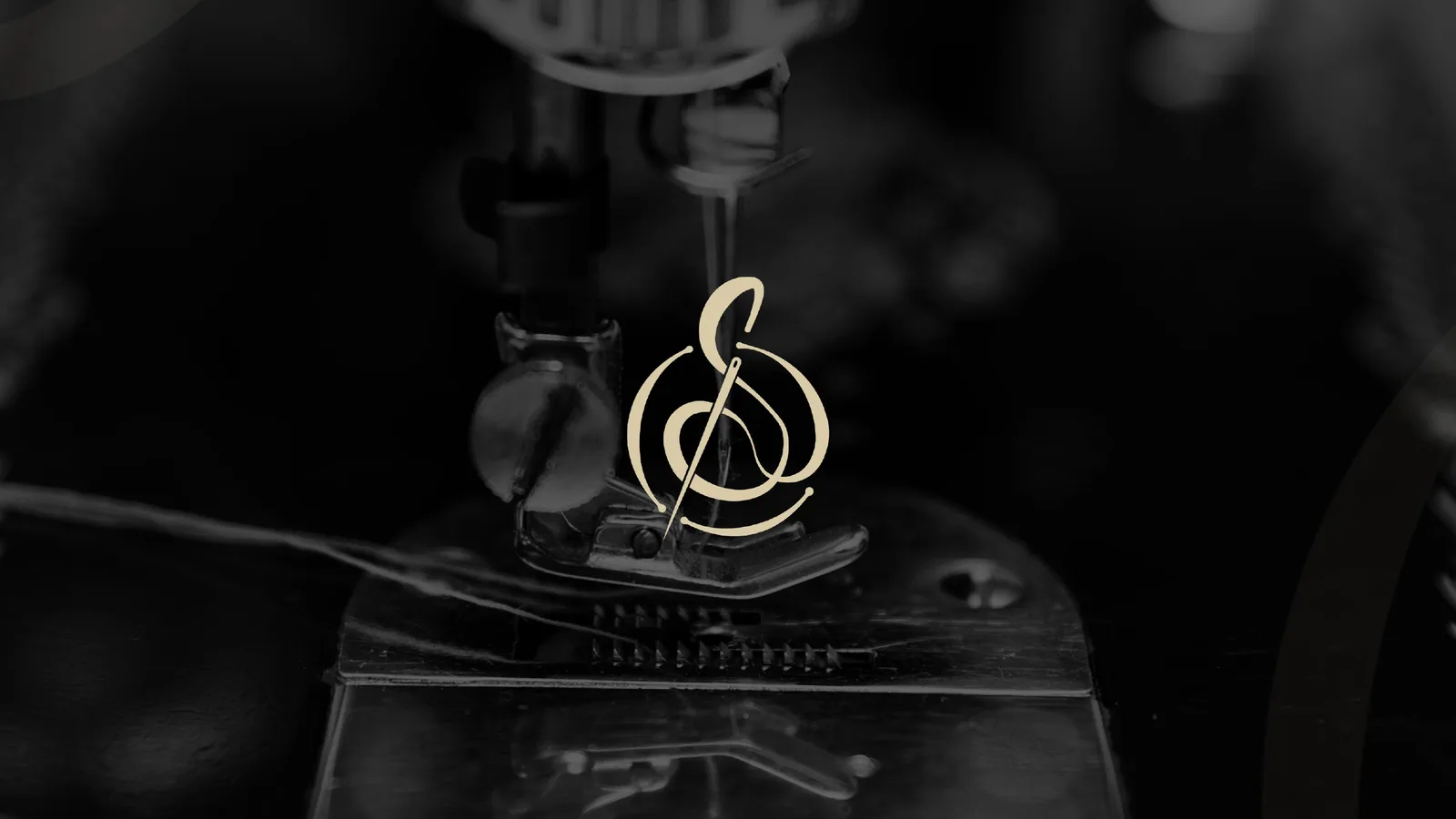Gold monogram logo over a monochrome vintage sewing machine needle